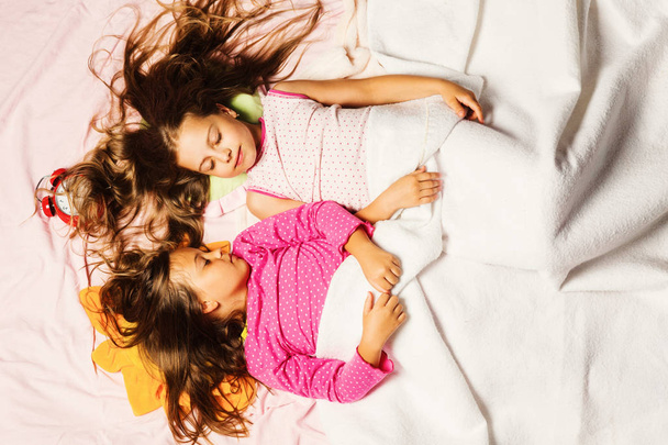Schoolgirls having pajama party. Childhood and good night concept - Fotó, kép