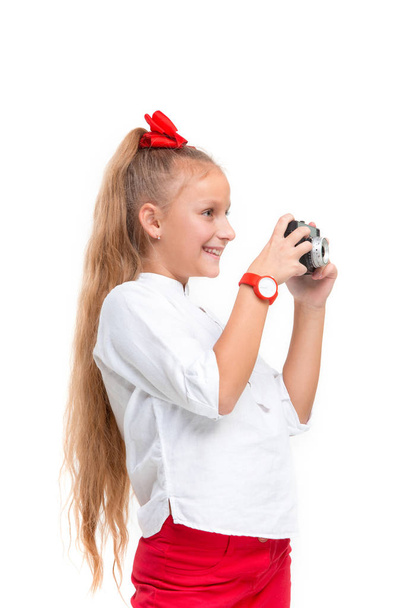 Full length portrait of cute little kid in stylish clothes with retro camera - Photo, Image