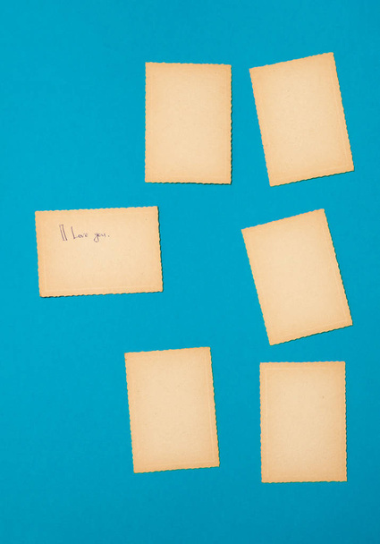 Old vintage paper set on the blue background. A lot of advertising notes as old photos. - Photo, Image