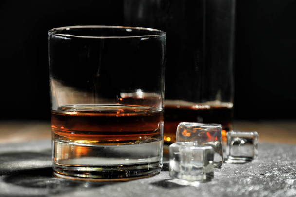 Glass of whiskey on table - Foto, afbeelding