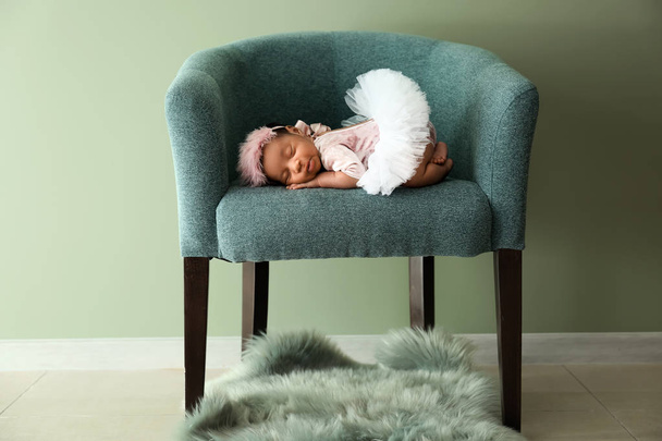 süßes afrikanisch-amerikanisches Baby schläft im weichen Sessel drinnen - Foto, Bild
