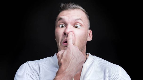 Man putting finger deep in his nose. Bad habit concept - Photo, Image