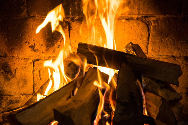 Wood burning in a cozy fireplace at home, keep warm. - Photo, Image
