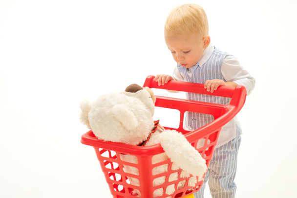 shopping for children. savings on purchases. little boy go shopping with full cart. little boy child in toy shop. happy childhood and care. Real happiness. Male shopping. Perfect quality. Hard choice - Fotoğraf, Görsel