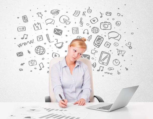 Young businesswoman with all kind of hand-drawn media icons in b - Photo, Image