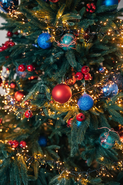 beautiful Christmas tree decorated with shiny baubles and lights garland   - Photo, Image