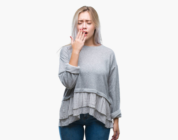 Young blonde woman over isolated background bored yawning tired covering mouth with hand. Restless and sleepiness. - Photo, image