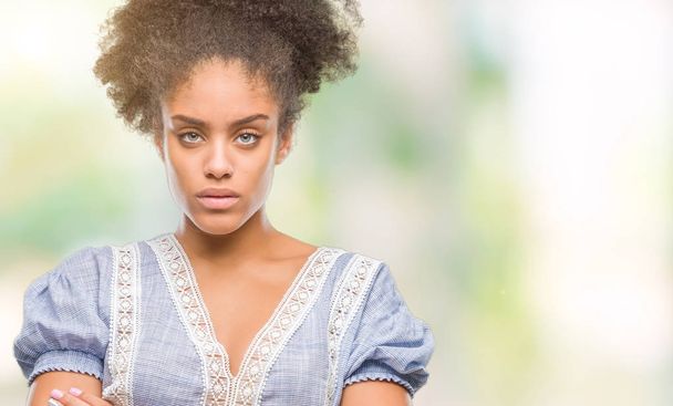 Young afro american woman over isolated background skeptic and nervous, disapproving expression on face with crossed arms. Negative person. - Foto, Bild
