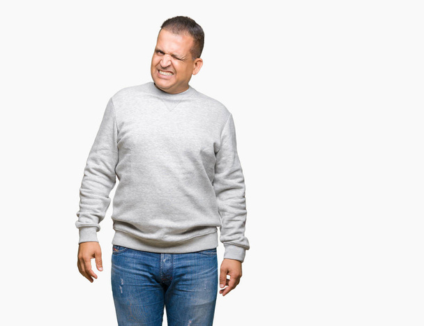 Middle age arab man wearing sport sweatshirt over isolated background winking looking at the camera with sexy expression, cheerful and happy face. - Foto, Imagem