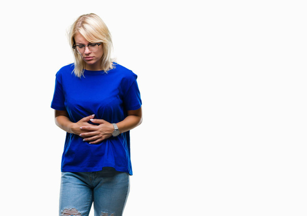 Young beautiful blonde woman wearing glasses over isolated background with hand on stomach because nausea, painful disease feeling unwell. Ache concept. - Photo, Image