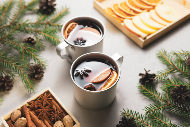 From above metal cups of mulled wine in Christmas tree branches on table - Foto, Imagem