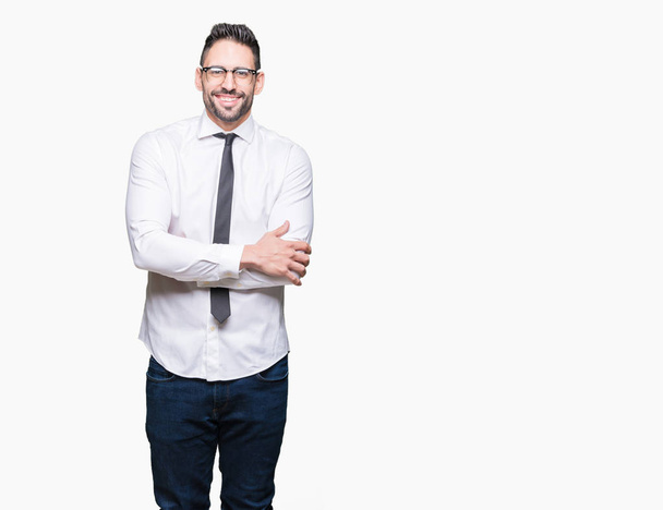Young handsome business man wearing glasses over isolated background happy face smiling with crossed arms looking at the camera. Positive person. - Photo, Image