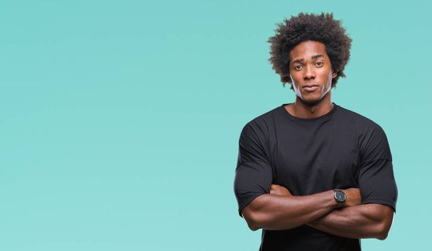 Afro american man over isolated background skeptic and nervous, disapproving expression on face with crossed arms. Negative person. - Photo, Image