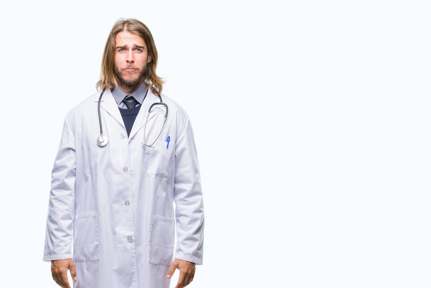 Young handsome doctor man with long hair over isolated background depressed and worry for distress, crying angry and afraid. Sad expression. - Photo, Image