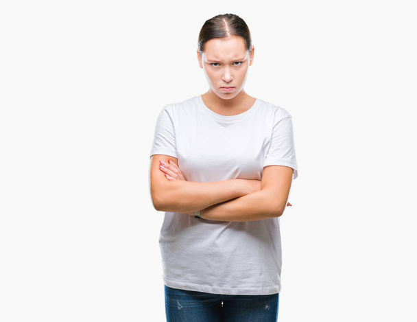 Young beautiful caucasian woman over isolated background skeptic and nervous, disapproving expression on face with crossed arms. Negative person. - Photo, Image