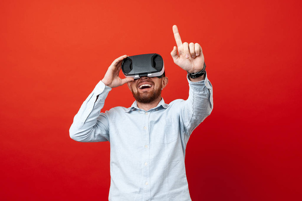 Cheerful man using Vr glasses and gesturi with hand - Photo, image