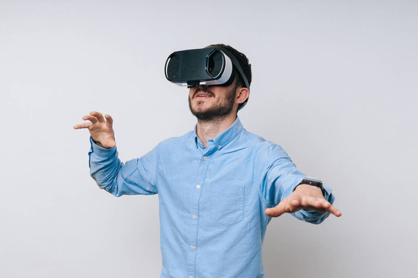 Photo of man using a virtual reality glasses for the first time - Фото, зображення