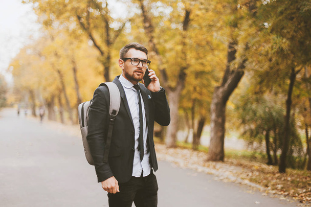 Photo of a business man talking on the phone with partner - Photo, Image
