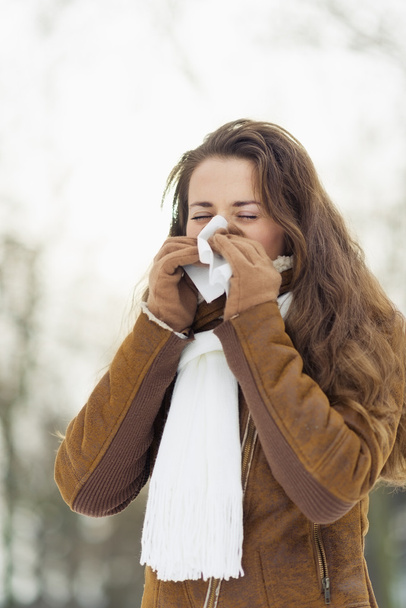 Woman blowing nose in winter outdoors - Zdjęcie, obraz