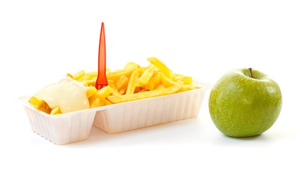 Choosing a healthy apple or an unhealthy portion of French fries - Photo, Image