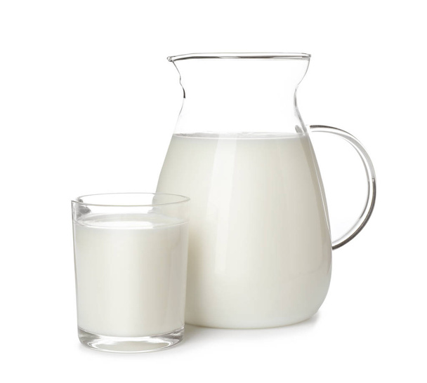 Glass and jug of fresh milk isolated on white - Фото, изображение
