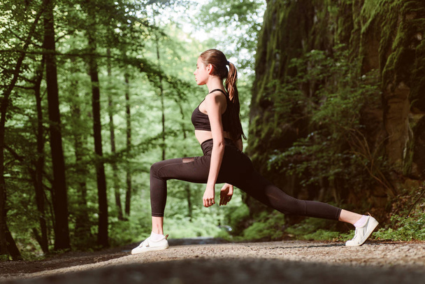 Dedicated to fitness. Healthy lifestyle concept. Sport and sportswear fashion. Sport success. Fitness woman with good athlete body. sporty woman training in green forest. fit your body lose weight - 写真・画像
