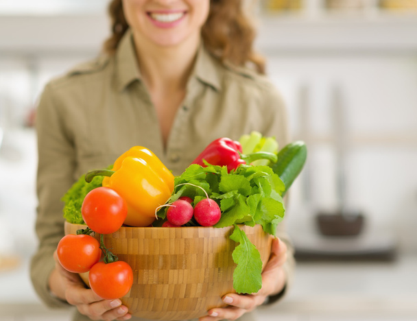 Closeup on plate of fresh vegetables in hand of young housewife - Foto, Imagen