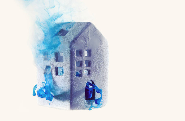 Κεραμικό σπιτάκι κάτω από το νερό με μπλε ακρυλικά χρώματα. Η έννοια των ακινήτων, Ενοικίαση, πώληση ή θέρμανση. Λευκός οίκος από παραμύθι. - Φωτογραφία, εικόνα