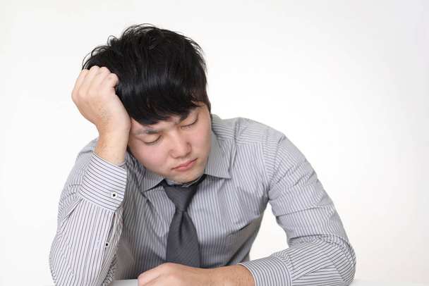 Tired and stressed Asian businessman - Photo, Image