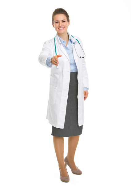 Happy medical doctor woman stretching hand for handshake - Photo, image