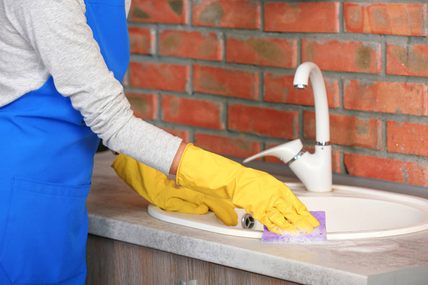 Woman cleaning kitchen sink with sponge, closeup - Foto, Imagem