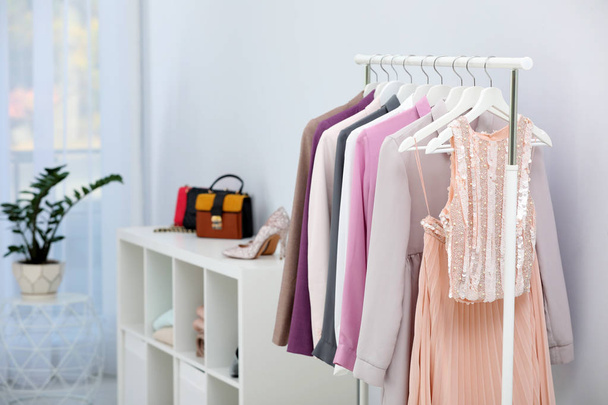 Racks with clothes in stylish dressing room interior - Foto, imagen