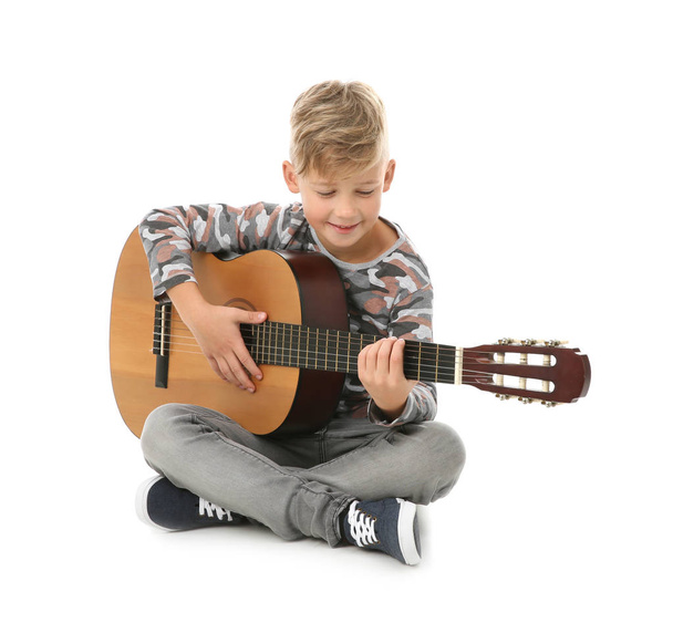 Portrait of little boy playing guitar on color background - Fotó, kép