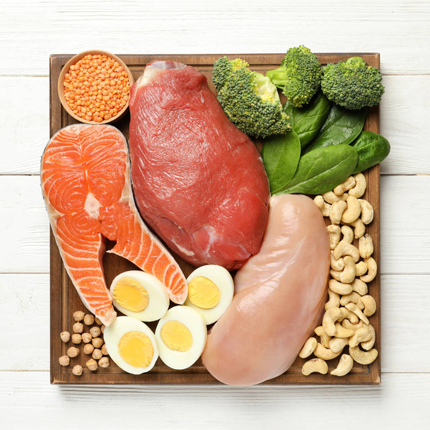 Set of natural food high in protein on wooden background, top view - Foto, afbeelding