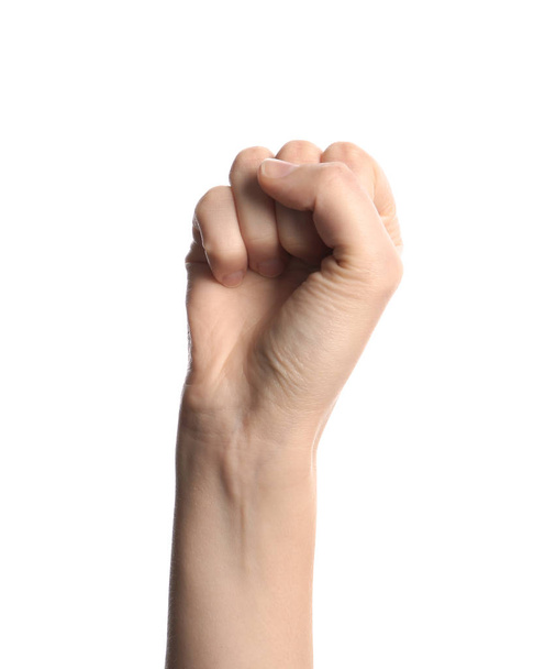 Молодая женщина показывает сжатый кулак на белом фоне
 - Фото, изображение