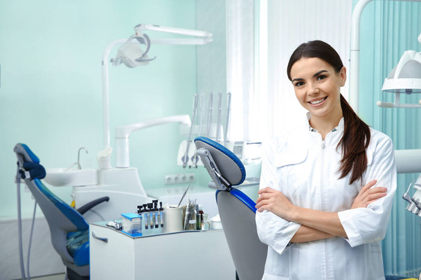 Professional dentist working with patient in modern clinic - Foto, imagen