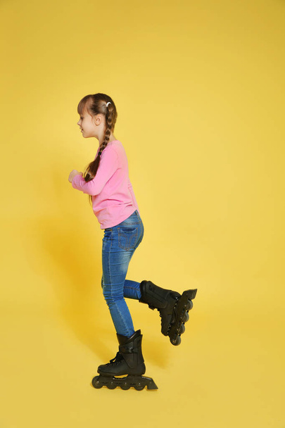 Girl with inline roller skates on color background - Фото, зображення