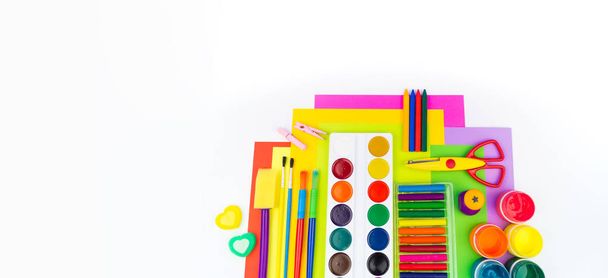 School accessories are laid out in the form of a rainbow. white background. Happy back to school student. Art and crafts for kids. Child learning rainbow colors, alphabet letters and numbers. - Фото, зображення
