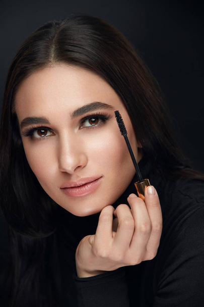 Makeup Cosmetics. Woman With Beauty Face Applying Black Mascara - Фото, изображение