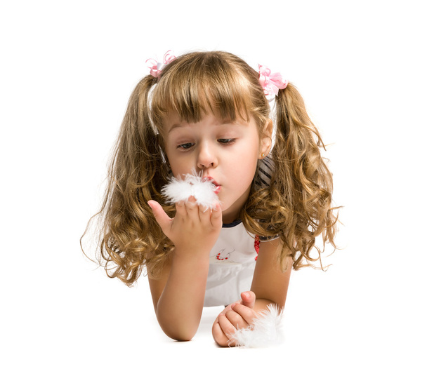 little girl blowing on a feather - Фото, зображення