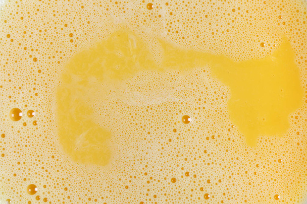 yellow beaten eggs background close up shot.  - Photo, Image