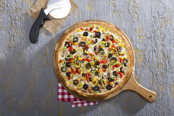 top view of delicious italian pizza with mozzarella cheese, olives and corn - Photo, Image