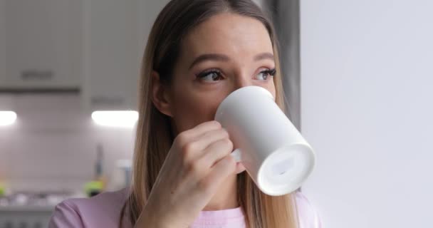 Young woman in pink t-thirt enjoy drinking tea with winter cookie at home - Metraje, vídeo