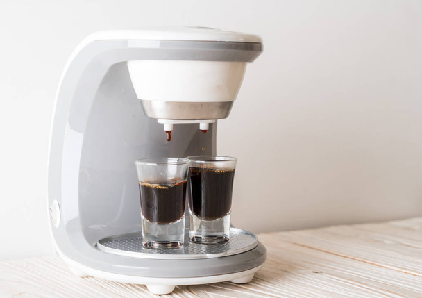coffee maker machine making coffee on wood background - Foto, afbeelding