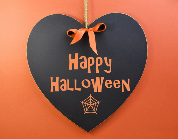На доске в форме сердца написано поздравительное послание на Хэллоуин
 - Фото, изображение
