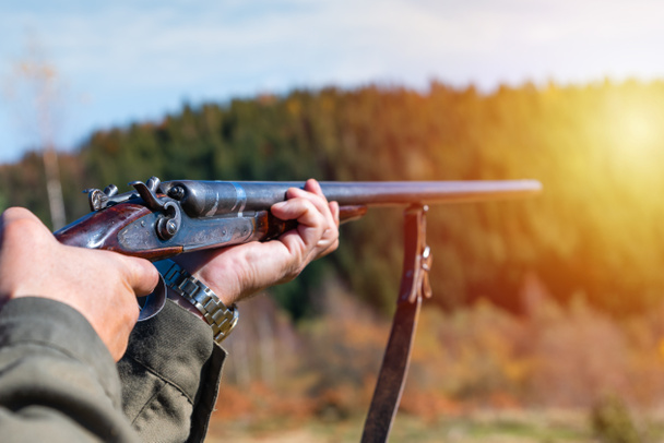 Hunter with retro shotgun aims at the target. Hunting season. - Photo, Image