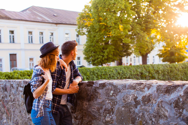 Young man holding lovely woman near the medieval castle - Fotografie, Obrázek