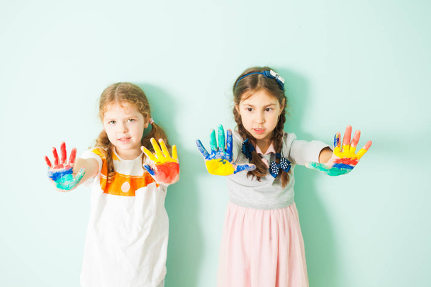 Two cute girls showing their painted hands - Foto, Bild