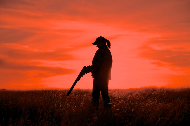 Woman Bird Hunter in Sunset - 写真・画像