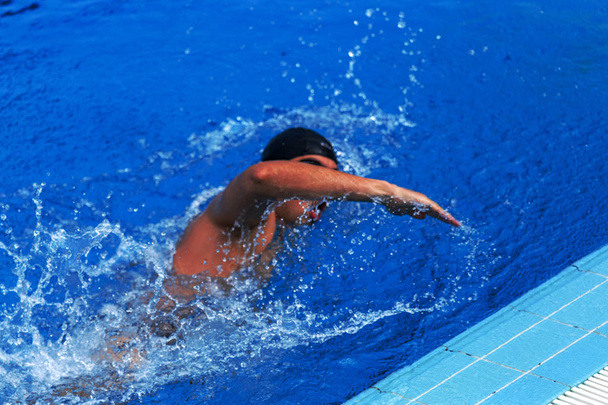 Varna, Bulgarije - 29 mei 2017: Openbare sport zwembad geopend. Lijnen scheiden paden in blauwe water van Olympisch zwembad. Atleten zwemmers opleiding in blauwe water van het zwembad - Foto, afbeelding